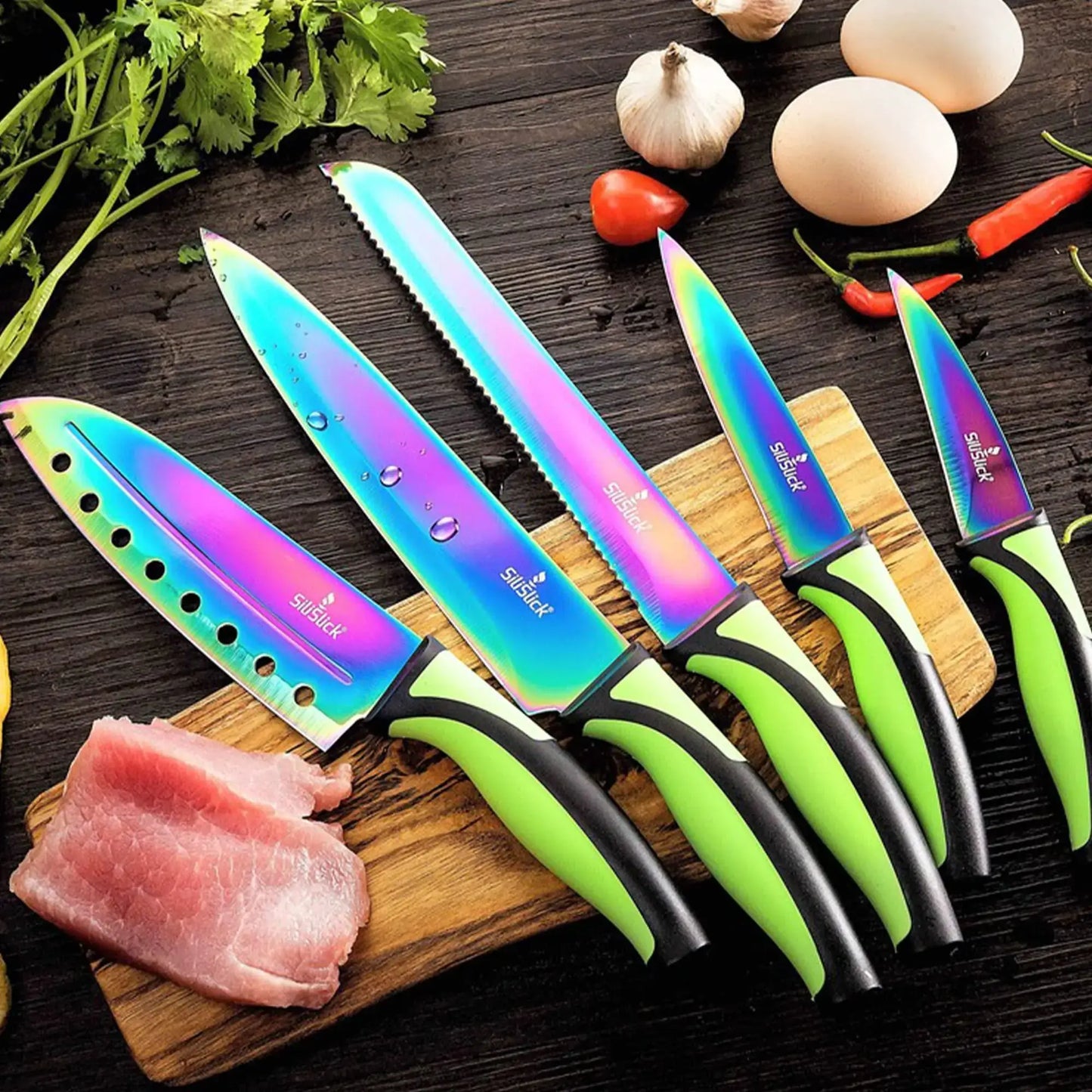 Colorful 5-piece kitchen knife set with sharpener on wooden cutting board with fresh ingredients.
