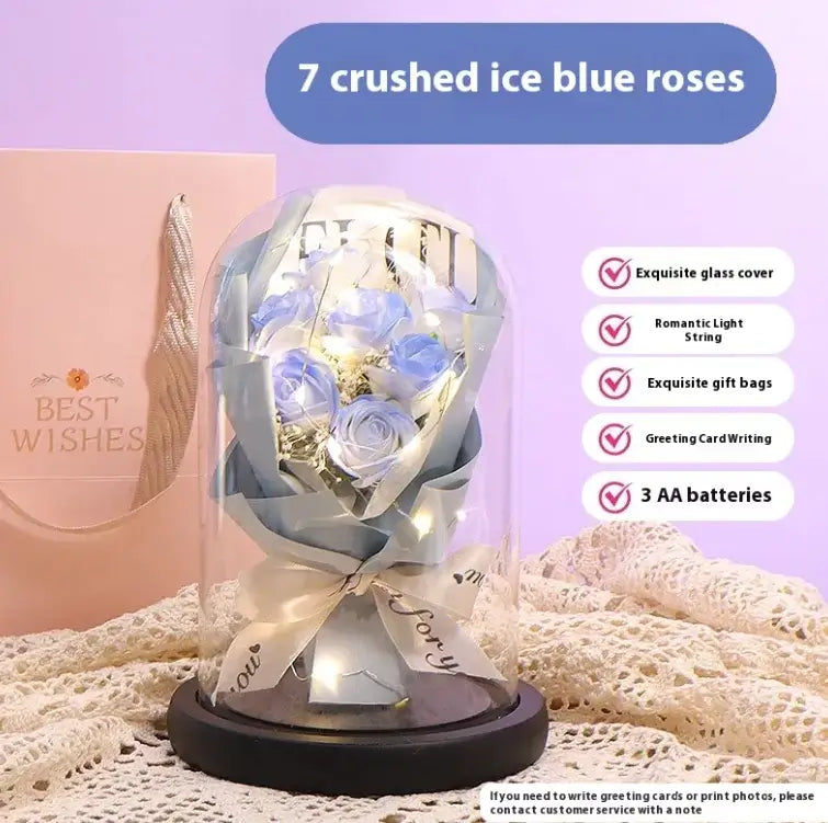 Elegant display of 7 crushed ice blue roses under glass dome with LED light and gift options.