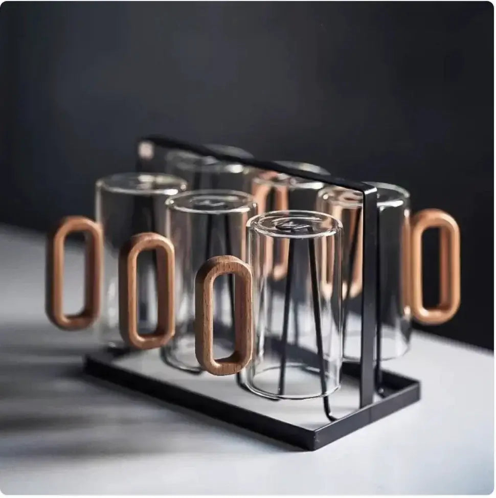 Smoky gray borosilicate beverage cups with wooden handles in a stylish black holder.