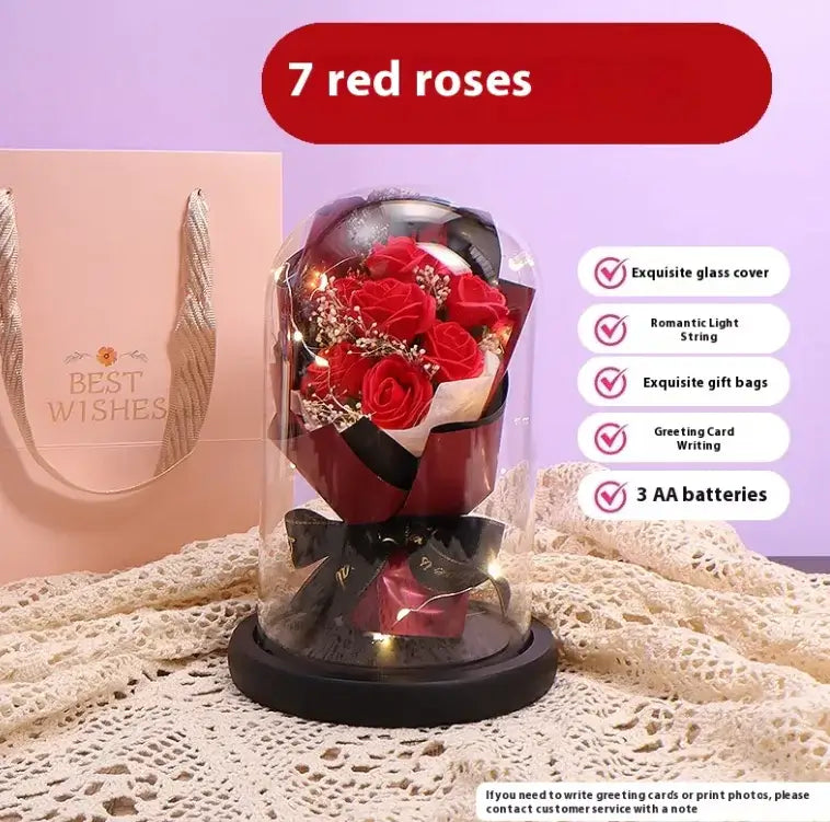 Elegant lighted display of 7 red roses in glass dome with a romantic light string, perfect for gifting.