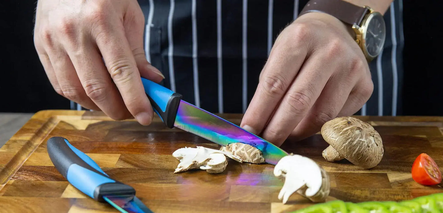 Person using a colorful kitchen knife to slice mushrooms on a wooden cutting board.