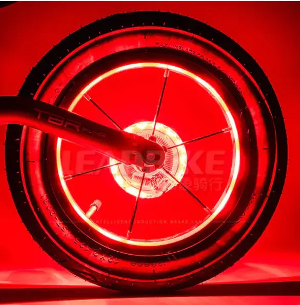 Red illuminated bike wheel showcasing vibrant lighting effects for enhanced visibility and style.