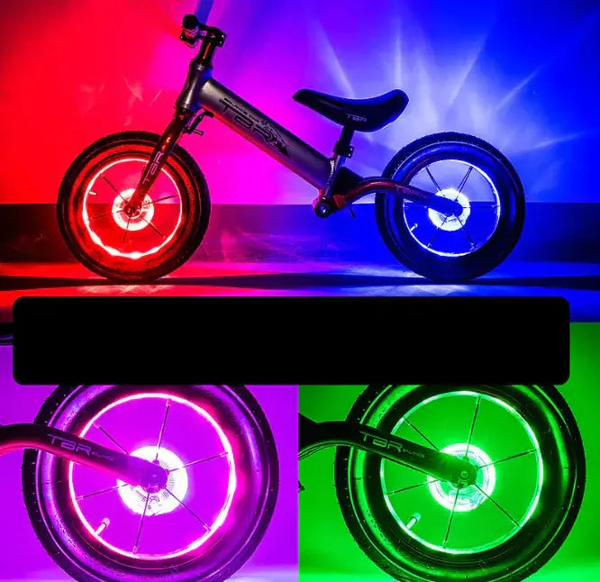 Colorful balance bike with illuminated rims in red, blue, pink, and green, designed for kids' play and fun.