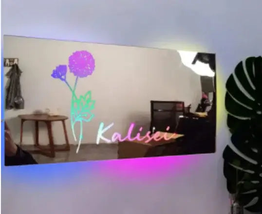 Glow Mirror with customizable design featuring flower illustration and colorful LED glow in stylish interior setting.