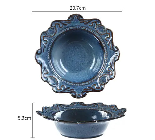 Blue porcelain bowl from the Elegant Baroque Dining Set, featuring intricate detailing and unique irregular shape.