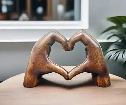 Heart-shaped resin statue depicting two hands forming a heart, perfect for home décor and gifts.