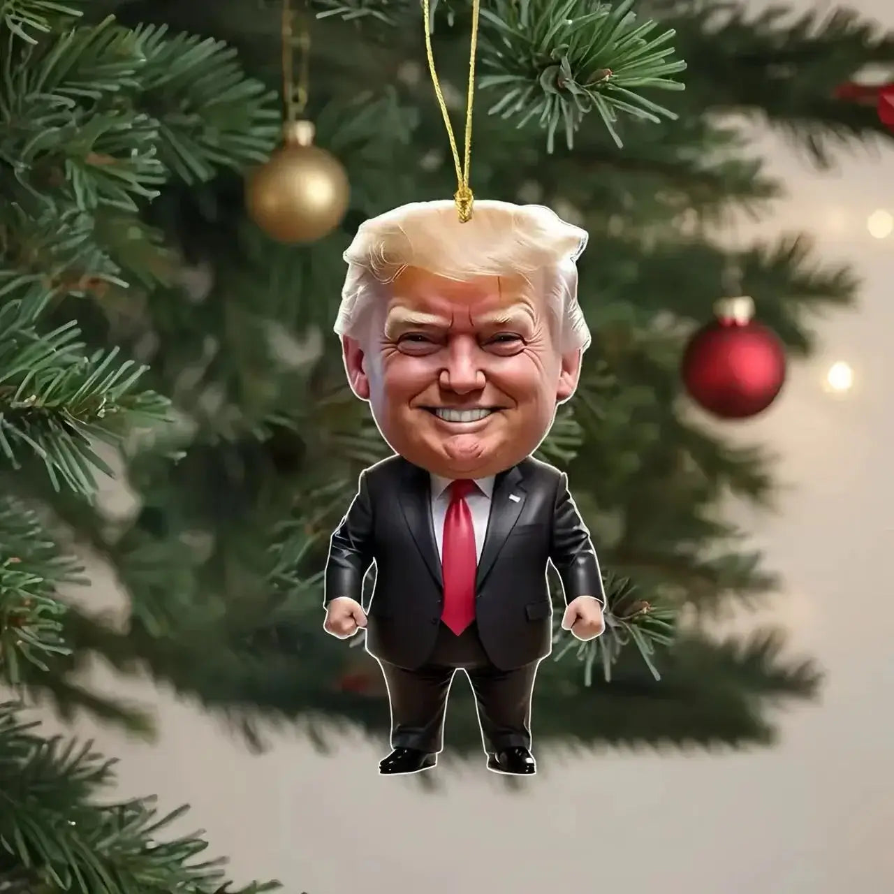 Cartoon-style ornament featuring a humorous caricature of a man in a suit, hanging from a Christmas tree.