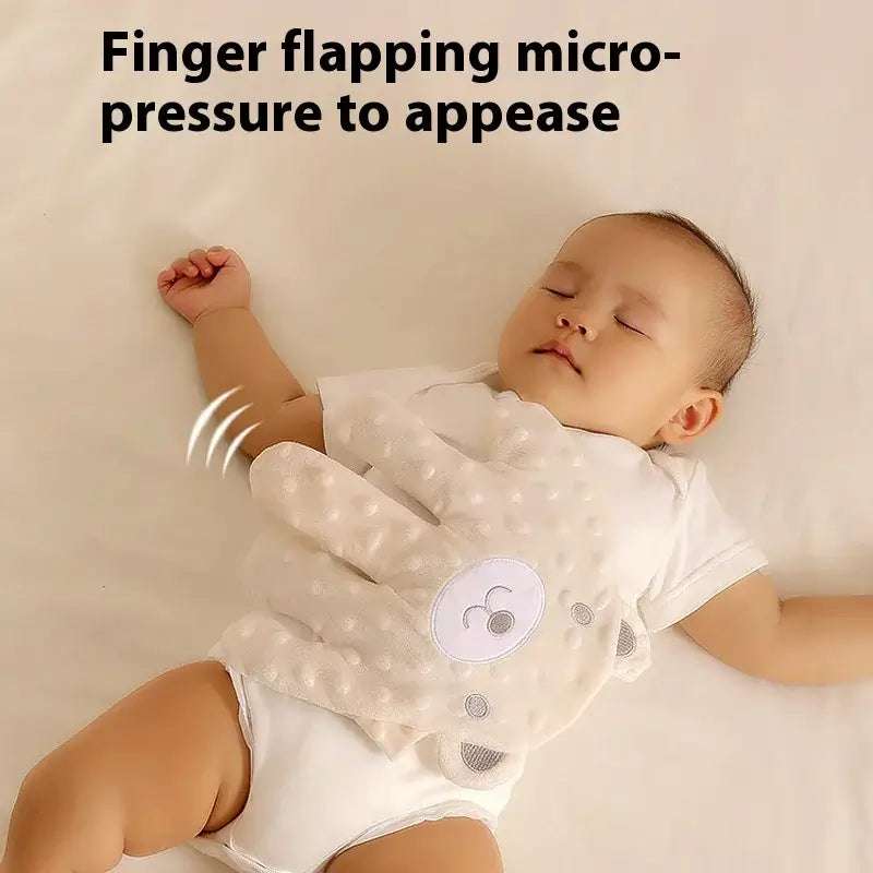 Baby sleeping peacefully with a gentle patting companion using finger-flapping micro-pressure.