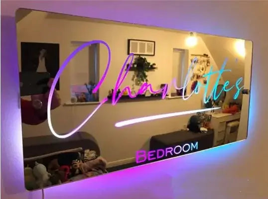 Personalized Glow Mirror with colorful LED lights in a stylish bedroom setting.