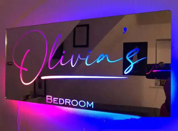 Personalized LED Glow Mirror with the name Olivia's, featuring colorful lights for a stylish bedroom decor.