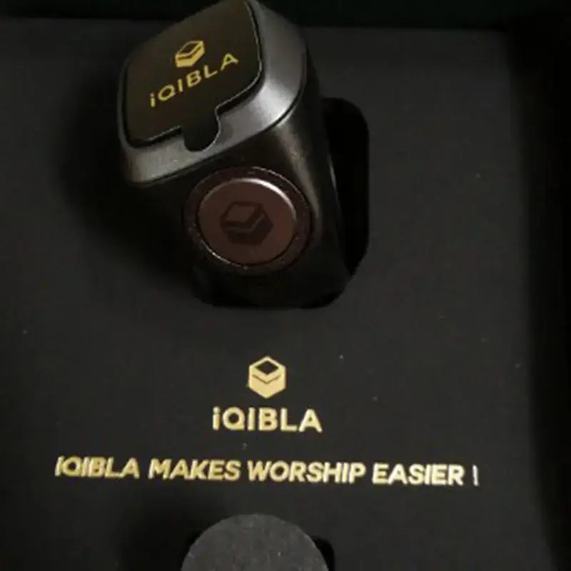 iQIBLA smart ring resting in a box with the text 'iQIBLA MAKES WORSHIP EASIER' for modern spiritual practice.