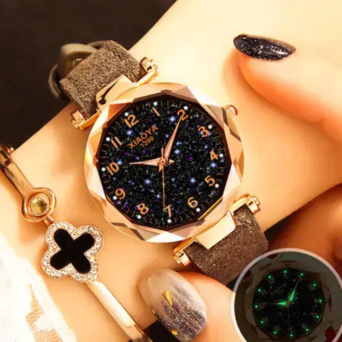 Quartz women's watch with luminous starry design, featuring a sparkling black dial and elegant strap.