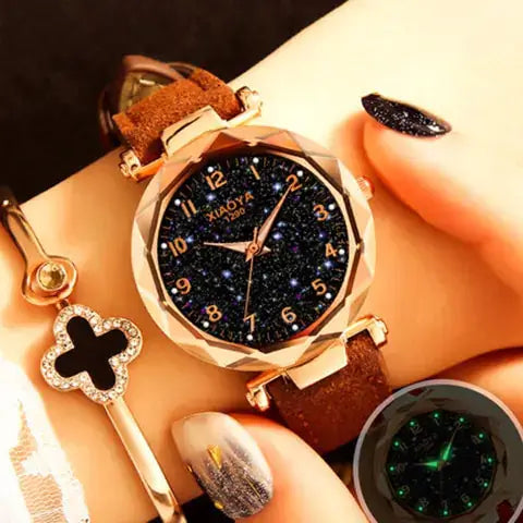 Quartz women's watch with a starry design, brown strap, and luminous features on a wrist.