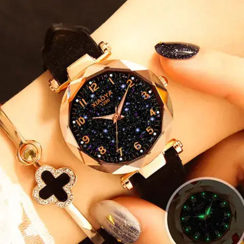 Quartz women's watch with luminous starry design, black strap, and elegant gold accents on wrist.