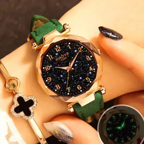 Quartz women's watch with luminous starry design on wrist, featuring a green strap and sparkling black dial.
