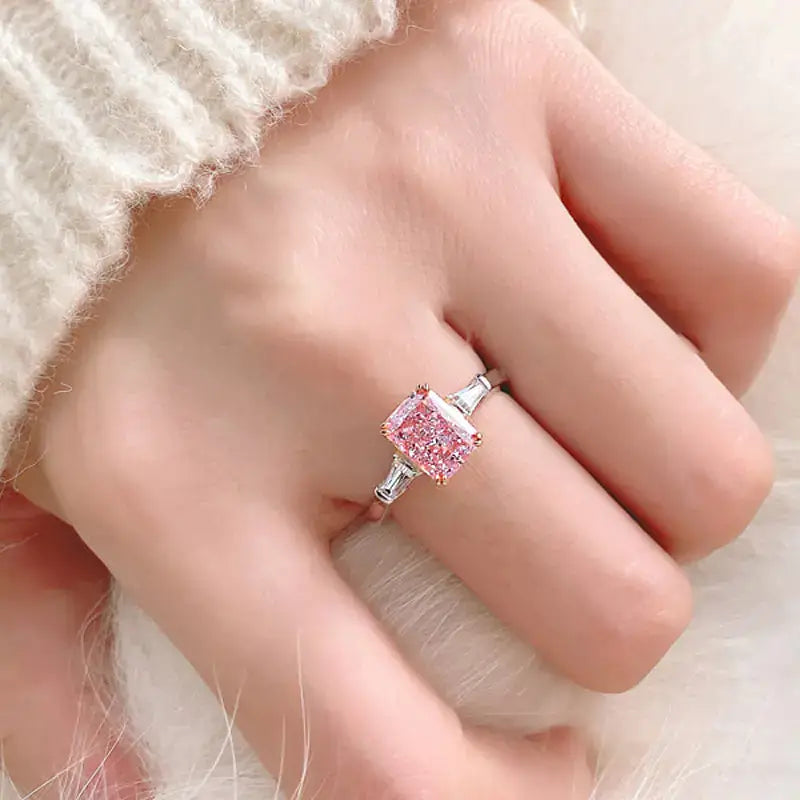 S925 sterling silver women's ring featuring a pink zircon gemstone on a hand with a cozy sweater.