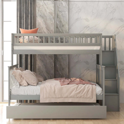 Gray twin over full bunk bed with trundle and staircase in a modern bedroom setting.