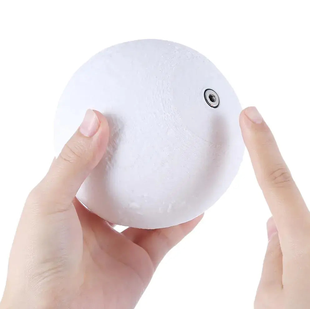 Hand touching a 3D Touch Control Moon Lamp, showcasing its unique design and interactive feature.