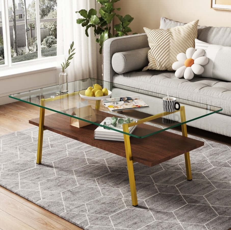 Modern rectangle coffee table with tempered glass top and gold metal legs in stylish living room setting.