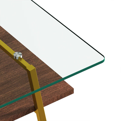 Close-up of a modern rectangle coffee table with a clear tempered glass top and gold metal legs.