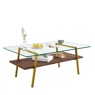 Modern rectangular coffee table with tempered glass top and gold metal legs, featuring a lower wooden shelf.