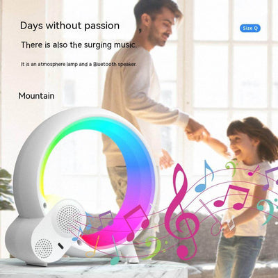Colorful Bluetooth speaker and atmosphere lamp with vibrant lights, enjoyed by a man and child dancing together.