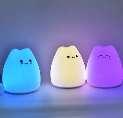 Colorful cartoon night lamps with cute faces, glowing in various colors, perfect for children's rooms.