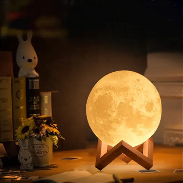 3D Touch Control Moon Lamp Night Light on a wooden stand, casting a warm glow in a cozy setting.