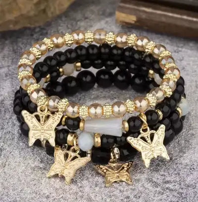 Butterfly Bliss Beaded Bracelets set featuring black and gold butterfly charms, colorful beads, and elegant design.