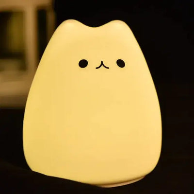 Cute cartoon cat-shaped night lamp with a soft glow, perfect for creating a whimsical bedtime ambiance.