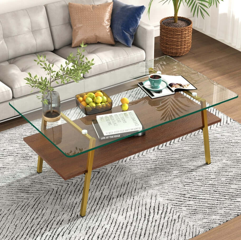 Modern rectangle coffee table with tempered glass top and gold metal legs in a stylish living room setting.