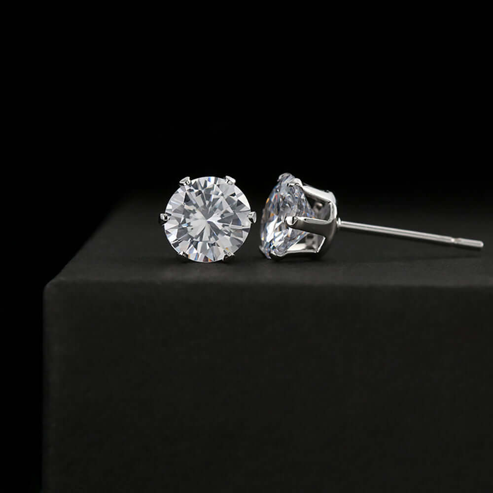 A pair of intertwined silver and gold rings, showcasing a sleek design with a polished finish.