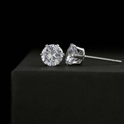 A pair of intertwined silver and gold rings, showcasing a sleek design with a polished finish.