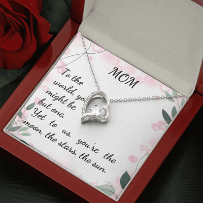 Stunning MOM Forever Love Necklace with heart pendant in gift box, featuring inspiring quote and rose background.