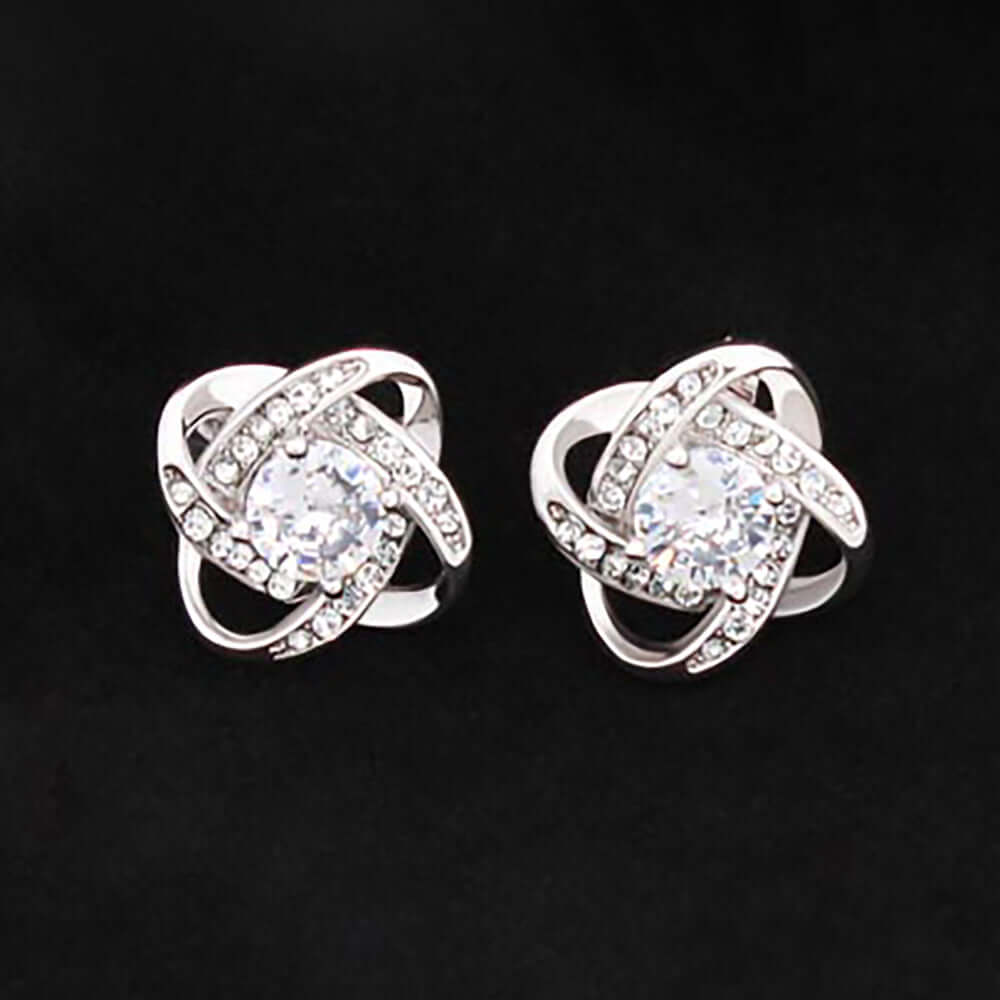 A pair of silver and gold rings, featuring intricate designs and a mix of shiny metallic finishes. One ring is adorned with a gemstone, while the other has diamond accents, showcasing their elegance as fashion accessories.