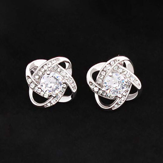 A pair of silver and gold rings, featuring intricate designs and a mix of shiny metallic finishes. One ring is adorned with a gemstone, while the other has diamond accents, showcasing their elegance as fashion accessories.