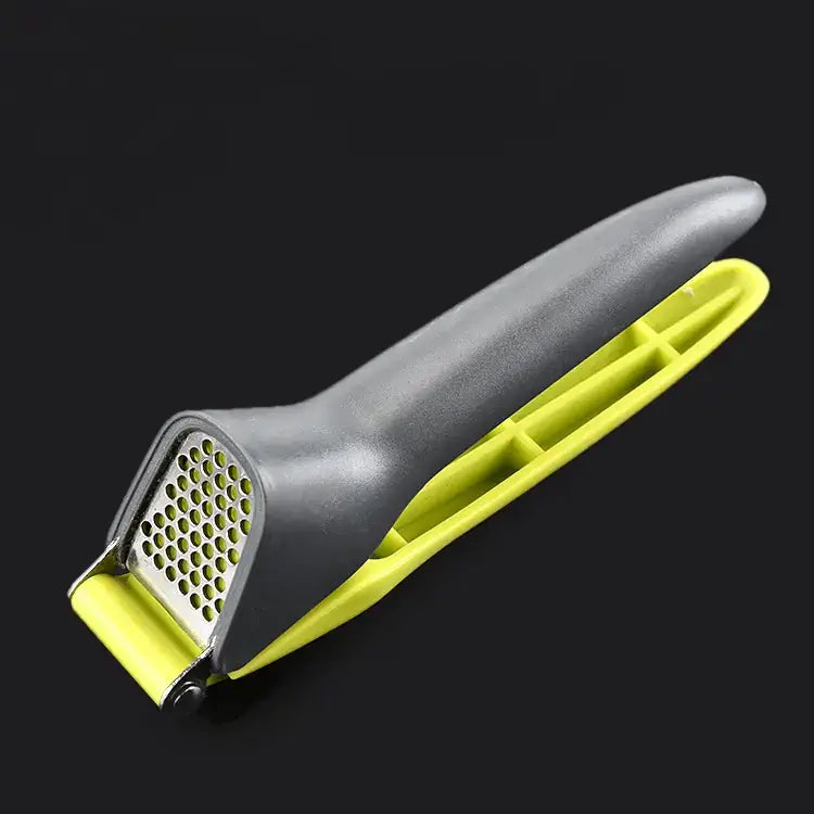 Innovative creative manual garlic press with plastic handle, perfect for effortless crushing of garlic cloves.