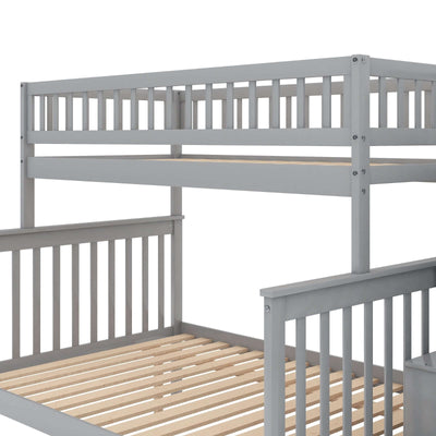 Gray twin over full bunk bed with trundle and staircase, showcasing wooden slats and safety railings.