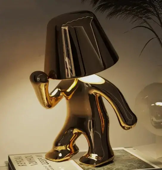 Sleek and stylish gold LED night lamp in unique walking figure design, perfect for modern decor.
