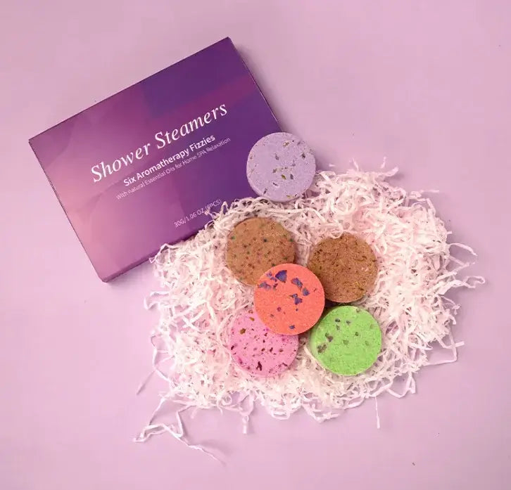 Essential oil shower steamers set with colorful aromatherapy tablets for relaxation and wellness.