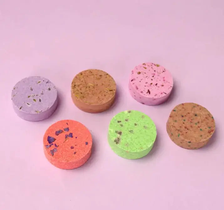 Colorful essential oil aromatherapy bath tablets in various shades for a relaxing spa-like experience.