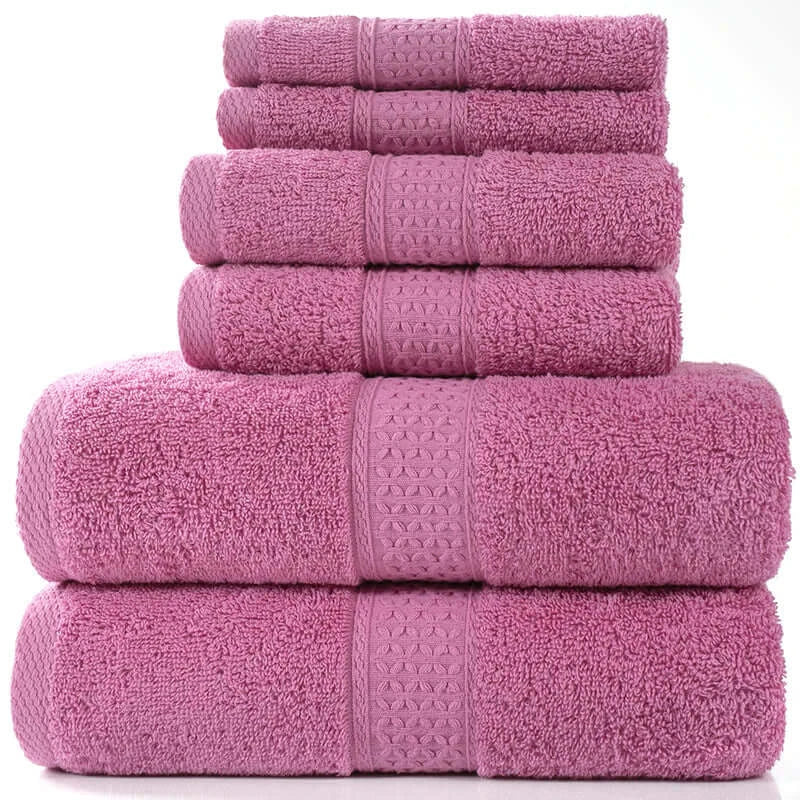 Six-piece set of soft pink cotton absorbent bath towels stacked neatly.