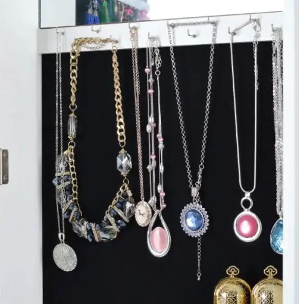 Collection of elegant necklaces displayed in a jewelry showcase with various styles and colors.