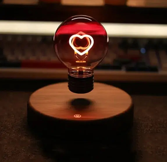Magnetic suspension night lamp with a heart-shaped bulb, gently levitating and emitting warm light.