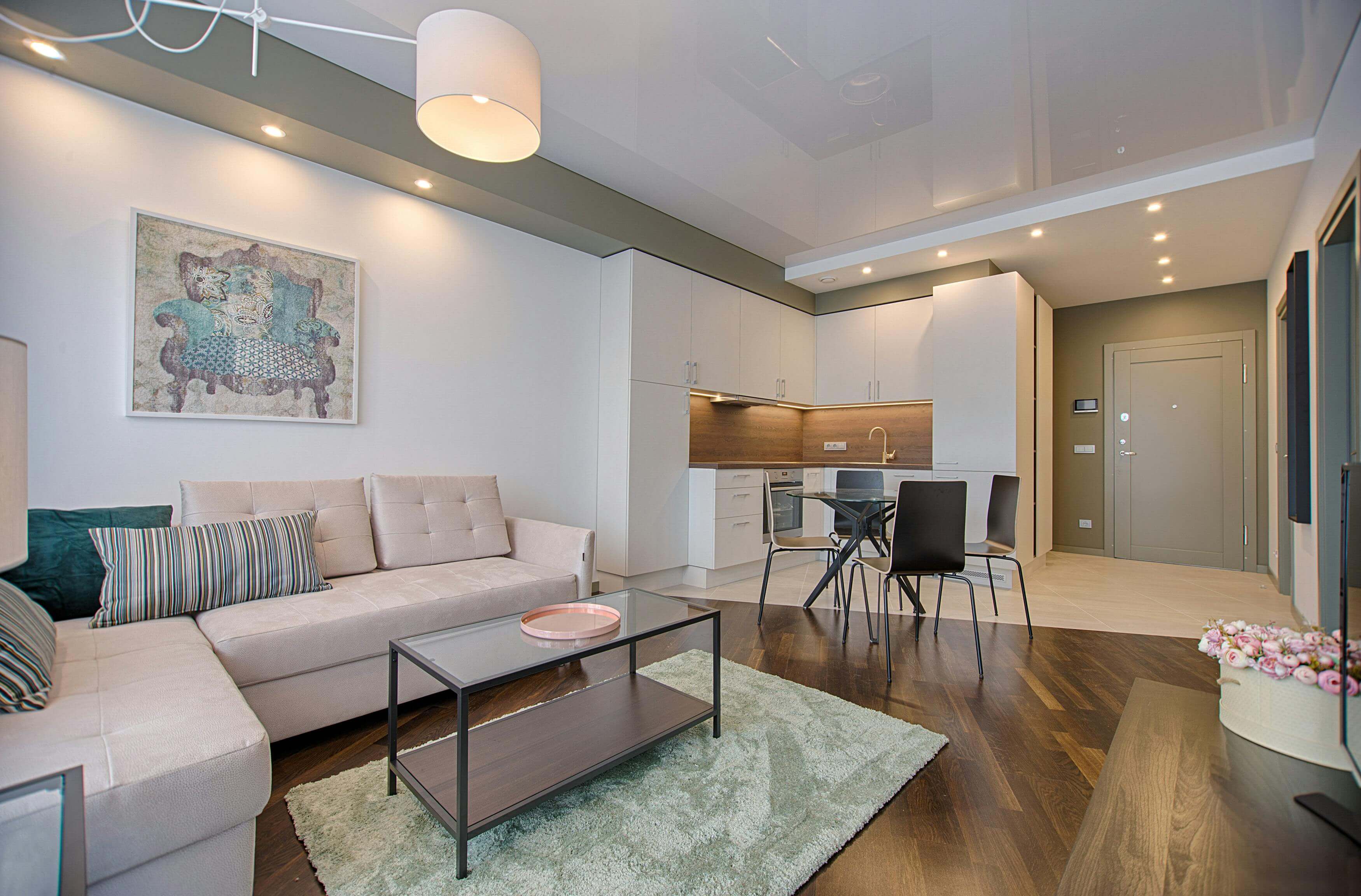 Modern living room interior featuring a cozy sofa, stylish chairs, and contemporary decor.