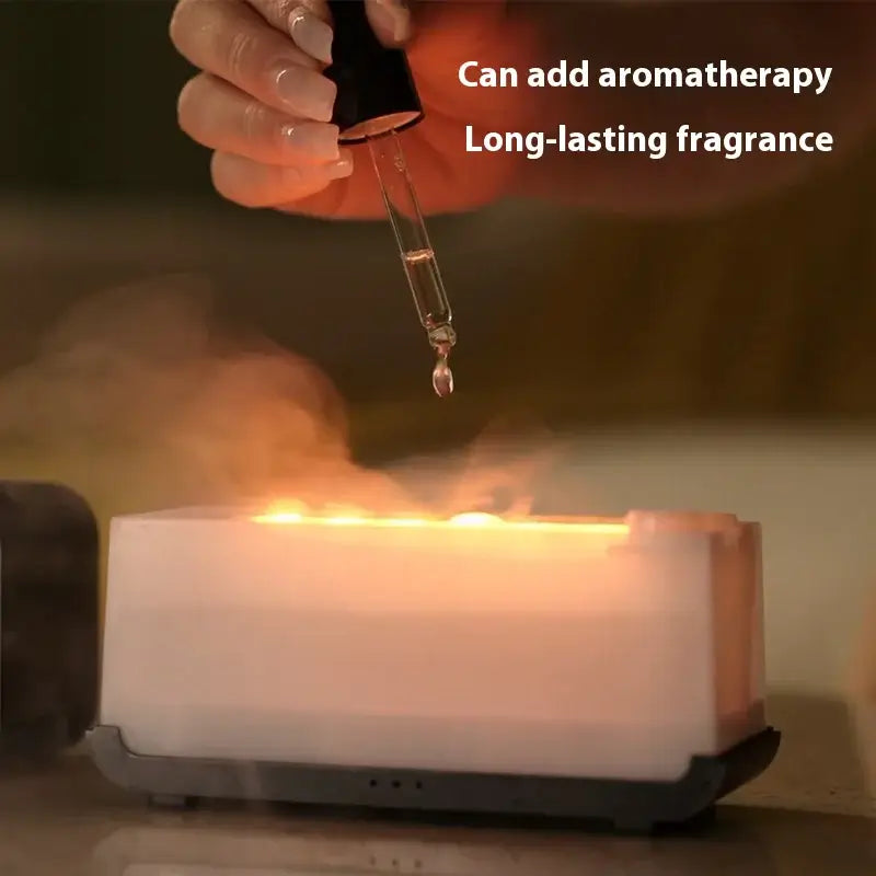 User adding essential oils to a flame-effect USB diffuser for aromatherapy and long-lasting fragrance.