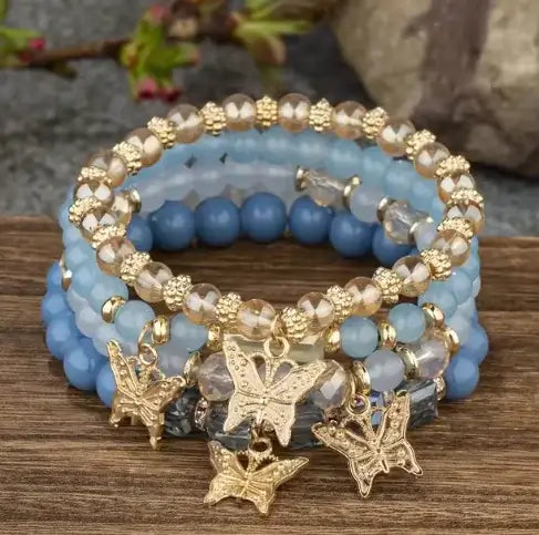 Butterfly Bliss Beaded Bracelets set showcasing blue and gold accents with butterfly charms, perfect for elegant accessories.