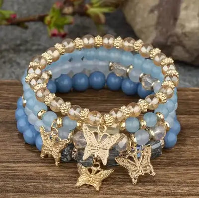 Butterfly Bliss Beaded Bracelets set showcasing blue and gold accents with butterfly charms, perfect for elegant accessories.