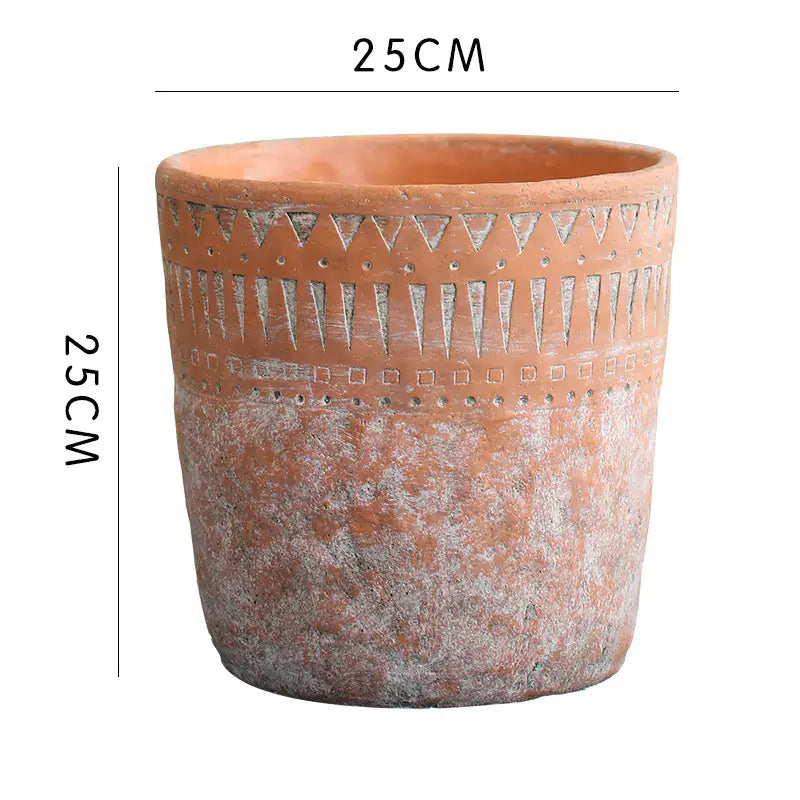 Vintage red clay pot with African design elements, perfect for enhancing home gardening aesthetics.